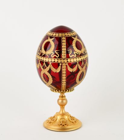 FABERGE.
Red-tinted cut-crystal egg with...