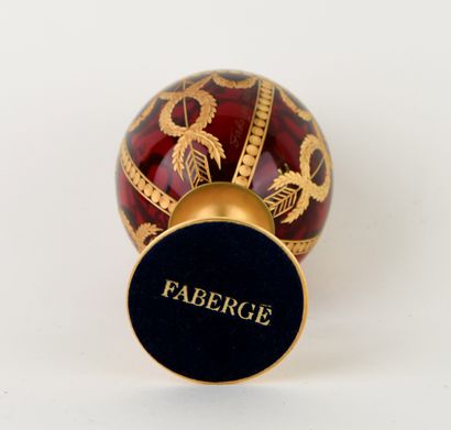 FABERGE.
Red-tinted cut-crystal egg with...