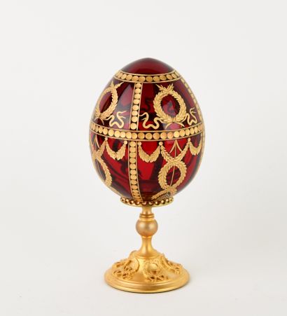 FABERGE.
Red-tinted cut-crystal egg with...