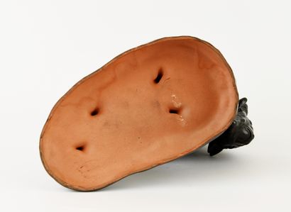 Black glazed ceramic subject featuring a...