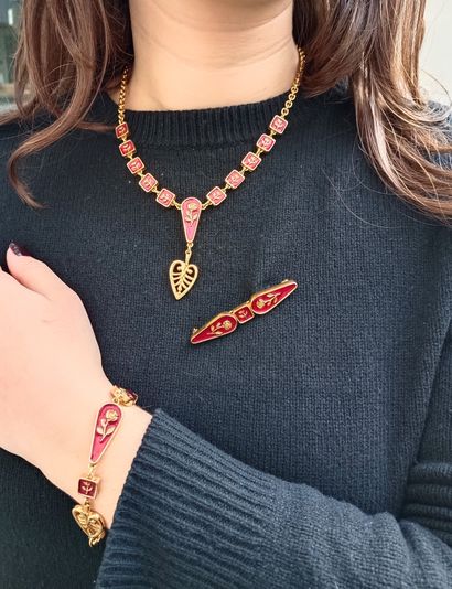 KENZO.
Set in gilt metal and red enamel with...