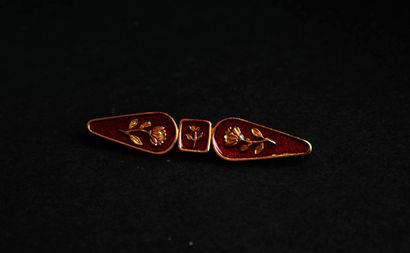 KENZO.
Set in gilt metal and red enamel with...