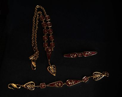 KENZO.
Set in gilt metal and red enamel with...