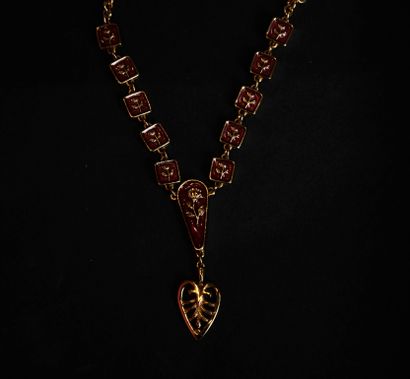 KENZO.
Set in gilt metal and red enamel with...