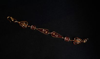 KENZO.
Set in gilt metal and red enamel with...