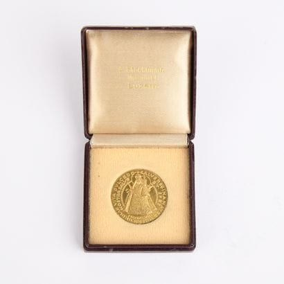Yellow gold medal featuring the Virgin Mary...