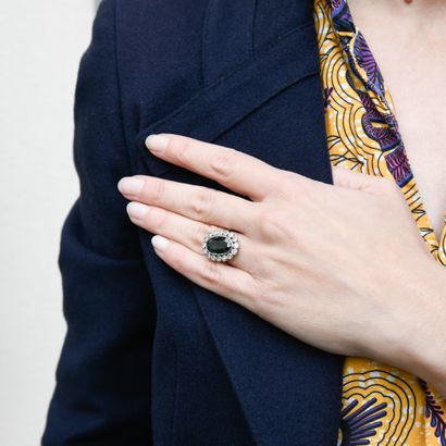 Ring centered on an oval-shaped blue-green...