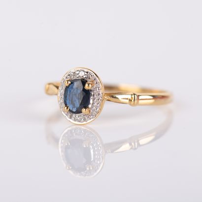 Modern ring set with an oval sapphire and...