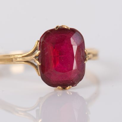 Antique ring centered with an imitation red...