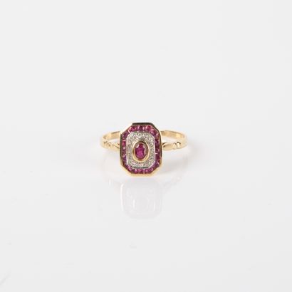 Modern ring centered on an oval ruby in a...
