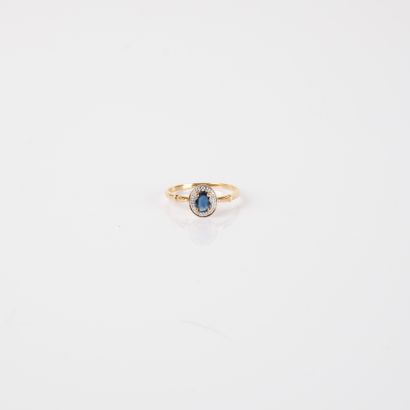 Modern ring set with an oval sapphire and...