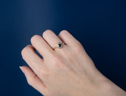 Modern ring set with an oval sapphire and...
