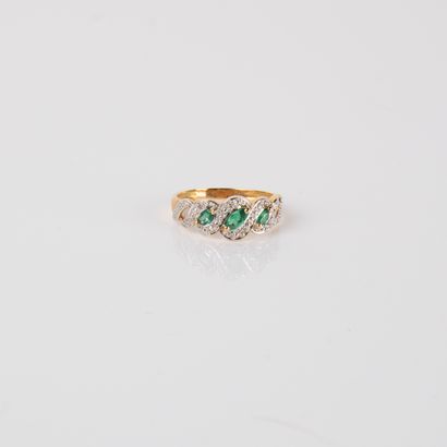 River ring with diamonds and three emeralds,...