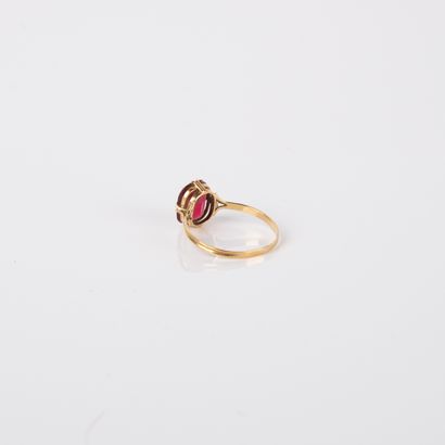 Antique ring centered with an imitation red...