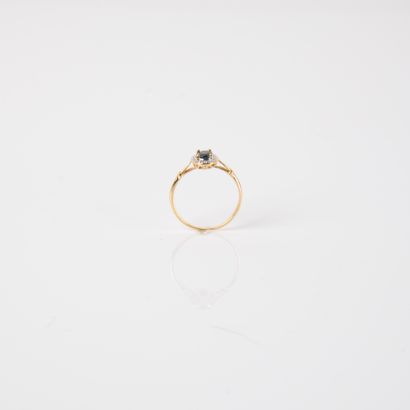 Modern ring set with an oval sapphire and...