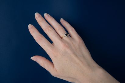 Modern ring set with an oval sapphire and...