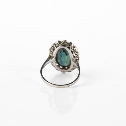 Ring centered on an oval-shaped blue-green...