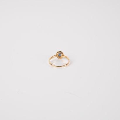 Modern ring set with an oval sapphire and...