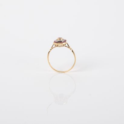 Modern ring centered on an oval ruby in a...