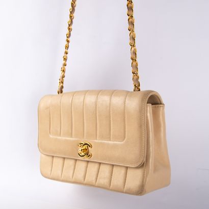 CHANEL
Beige lambskin bag with vertical stitching.
Flap...
