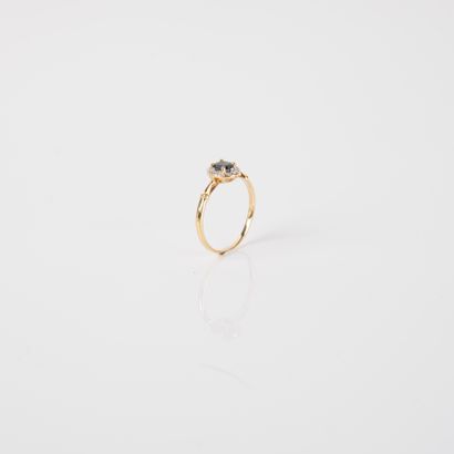 Modern ring set with an oval sapphire and...