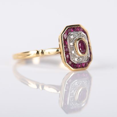 Modern ring centered on an oval ruby in a...