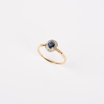 Modern ring set with an oval sapphire and...