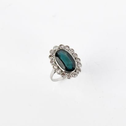 Ring centered on an oval-shaped blue-green...