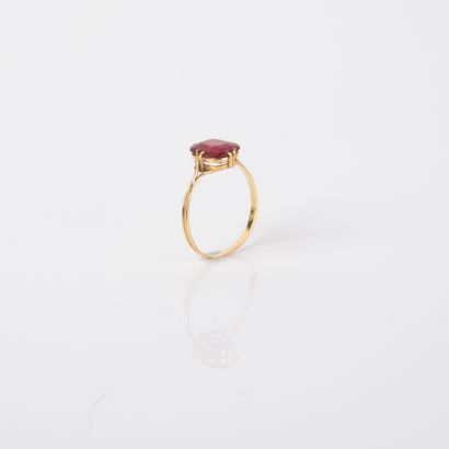 Antique ring centered with an imitation red...