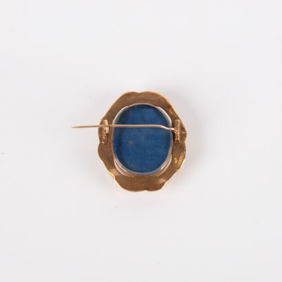 Oval-shaped reliquary brooch containing braided...