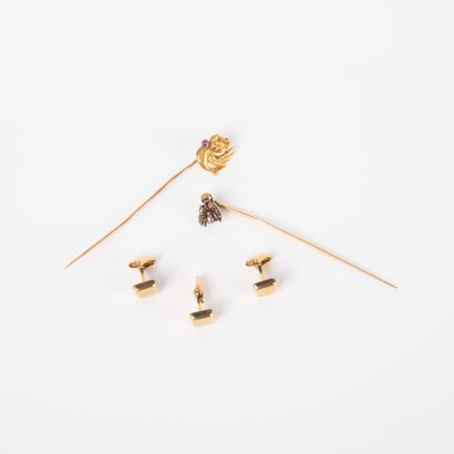 Two 18k (750 thousandths) gold pins, one...