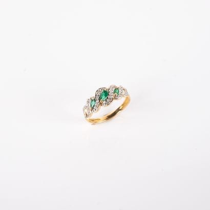 River ring with diamonds and three emeralds,...