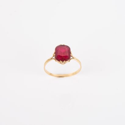 Antique ring centered with an imitation red...