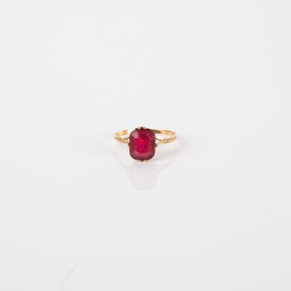 Antique ring centered with an imitation red...