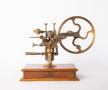 Brass and metal watchmaker's lathe on wooden...