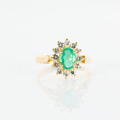Pompadour ring centered on an oval emerald...