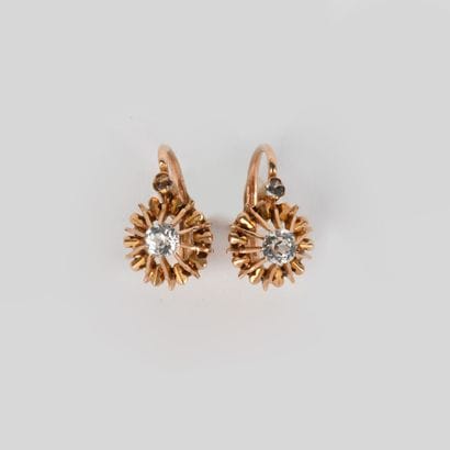 Pair of earrings in yellow gold holding white...