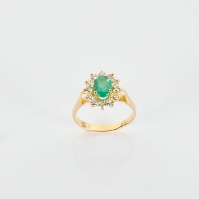 Pompadour ring centered on an oval emerald...