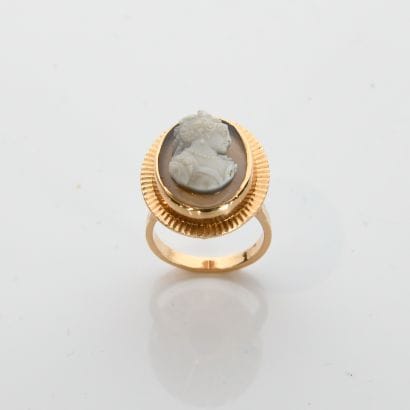 Yellow gold ring with striated setting holding...