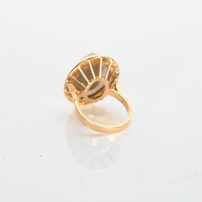 Yellow gold ring with striated setting holding...