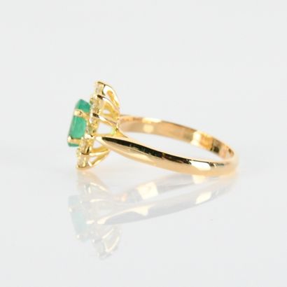 Pompadour ring centered on an oval emerald...