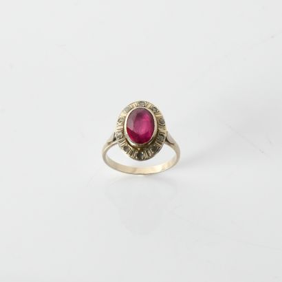 18K (750
oval bezel ring centered on a synthetic
ruby,...