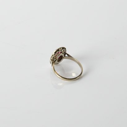 18K (750
oval bezel ring centered on a synthetic
ruby,...