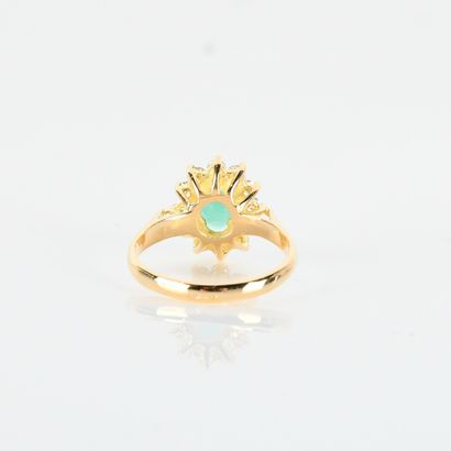 Pompadour ring centered on an oval emerald...
