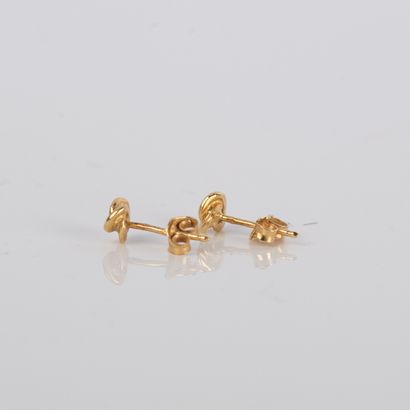 Pair of earrings representing a knot, in...