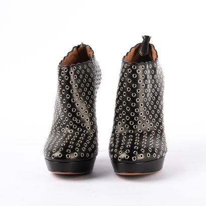 ALAÏA PARIS. Black leather heeled boots embellished...