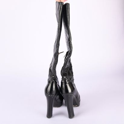 YVES SAINT LAURENT. Round-toe heeled boots...