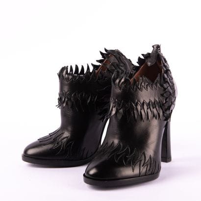 ALAÏA PARIS. Heeled boots with round toes...