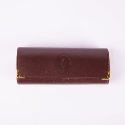 CARTIER, Must
Glasses case in burgundy leather
7...