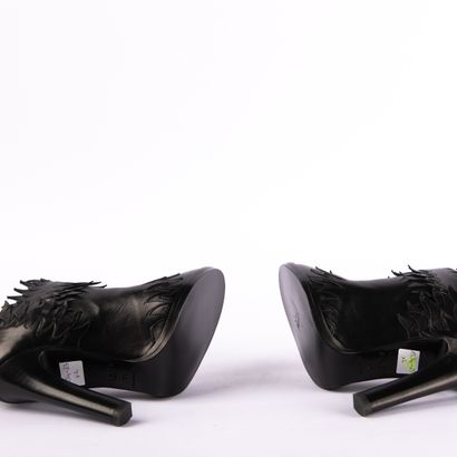 ALAÏA PARIS. Heeled boots with round toes...
